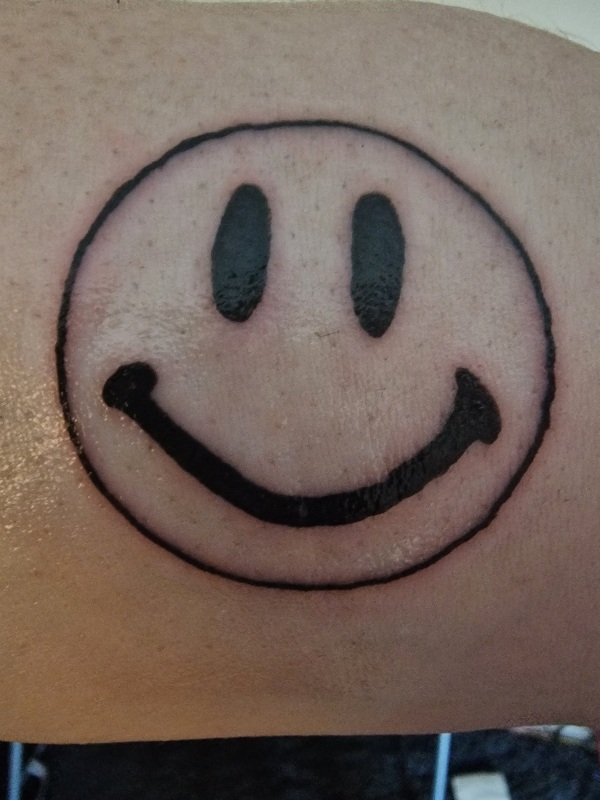 Tattoo of a smiley face